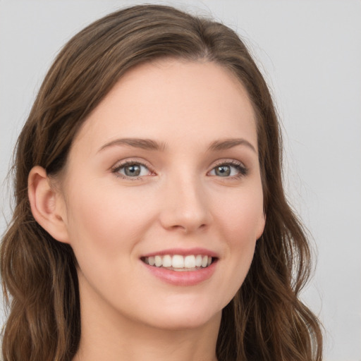 Joyful white young-adult female with long  brown hair and grey eyes