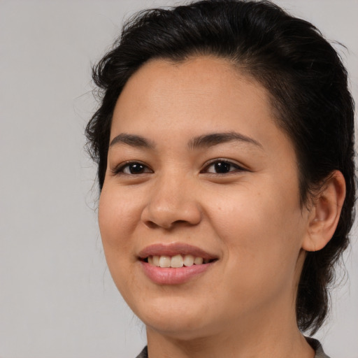 Joyful asian young-adult female with medium  brown hair and brown eyes