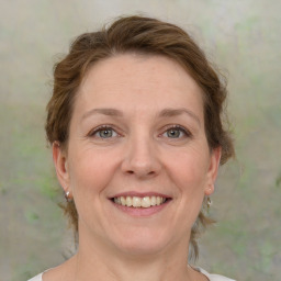 Joyful white adult female with medium  brown hair and grey eyes