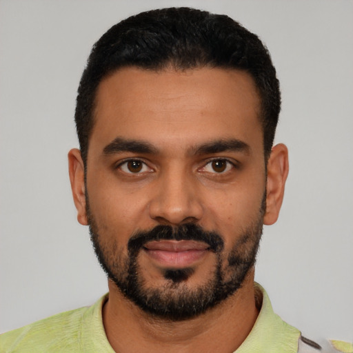 Joyful latino young-adult male with short  black hair and brown eyes