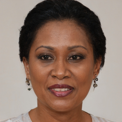 Joyful black adult female with short  brown hair and brown eyes