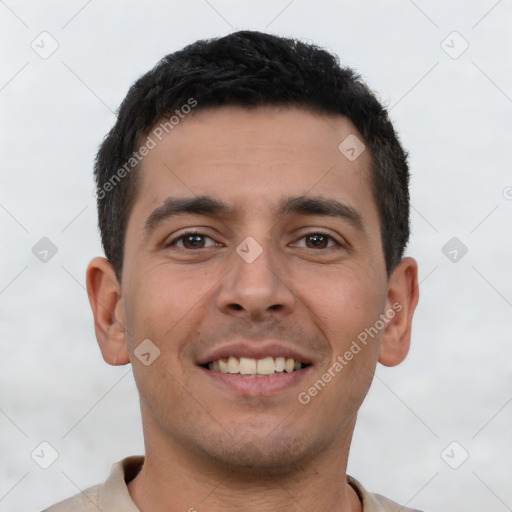 Joyful latino young-adult male with short  brown hair and brown eyes