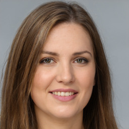 Joyful white young-adult female with long  brown hair and green eyes