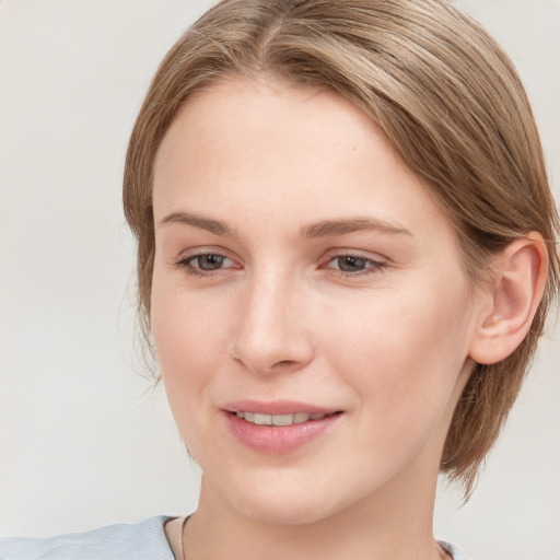 Joyful white young-adult female with medium  brown hair and blue eyes