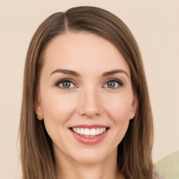 Joyful white young-adult female with long  brown hair and green eyes