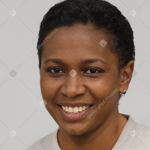 Joyful black young-adult female with short  black hair and brown eyes