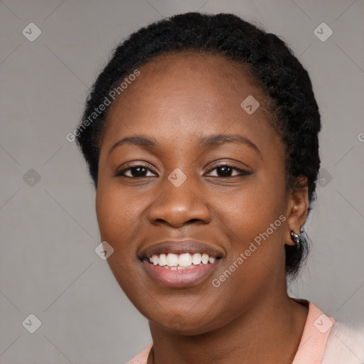 Joyful black young-adult female with short  black hair and brown eyes