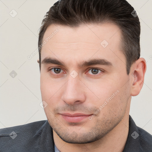 Joyful white young-adult male with short  brown hair and brown eyes