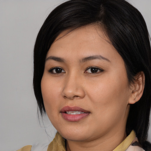 Joyful asian young-adult female with medium  brown hair and brown eyes