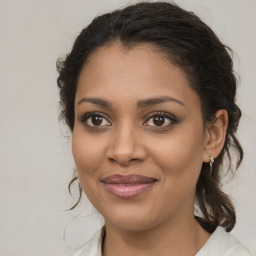 Joyful black young-adult female with medium  brown hair and brown eyes