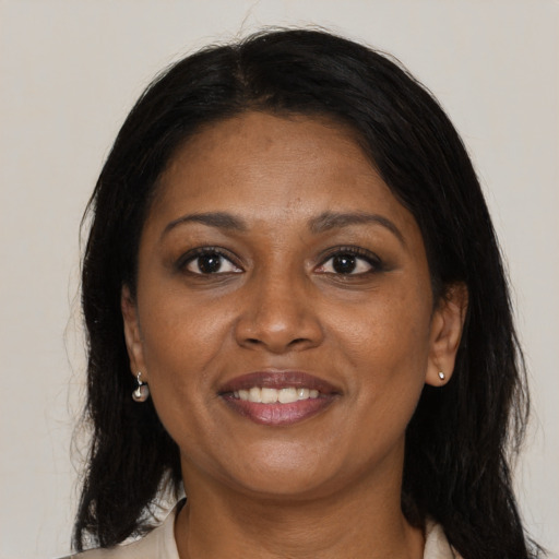 Joyful black adult female with medium  brown hair and brown eyes