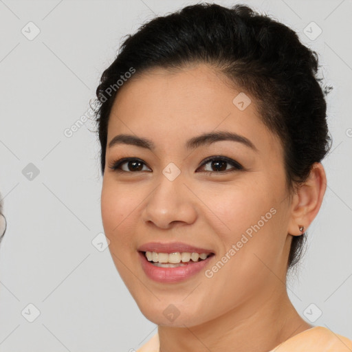 Joyful latino young-adult female with short  brown hair and brown eyes