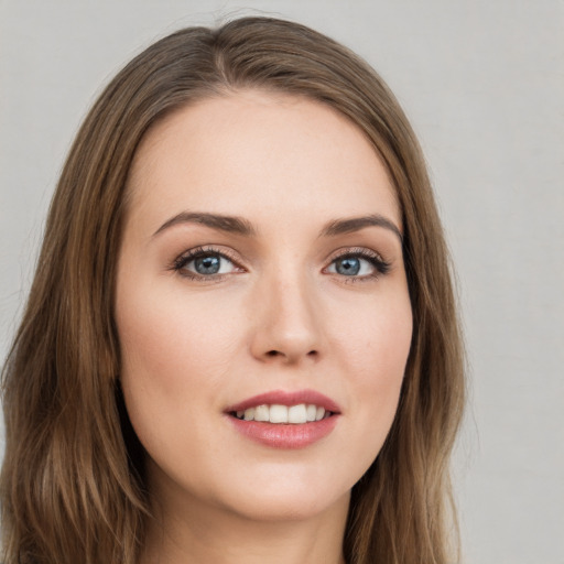 Joyful white young-adult female with long  brown hair and grey eyes