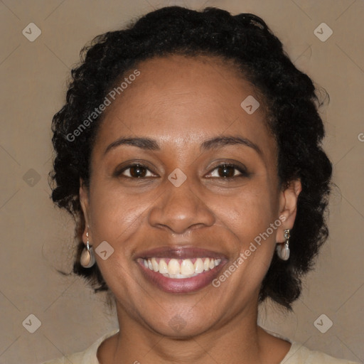 Joyful black adult female with medium  brown hair and brown eyes