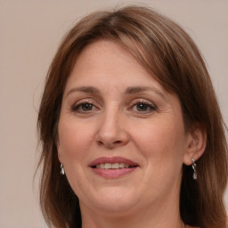 Joyful white adult female with medium  brown hair and grey eyes