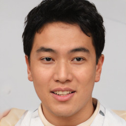 Joyful asian young-adult male with short  black hair and brown eyes