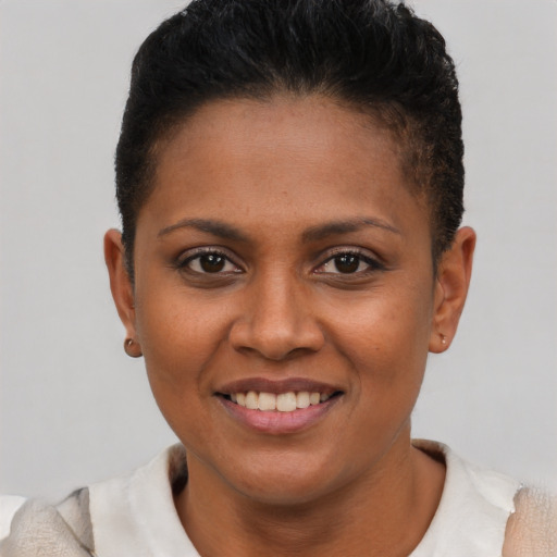 Joyful latino young-adult female with short  brown hair and brown eyes