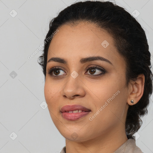 Joyful latino young-adult female with long  black hair and brown eyes