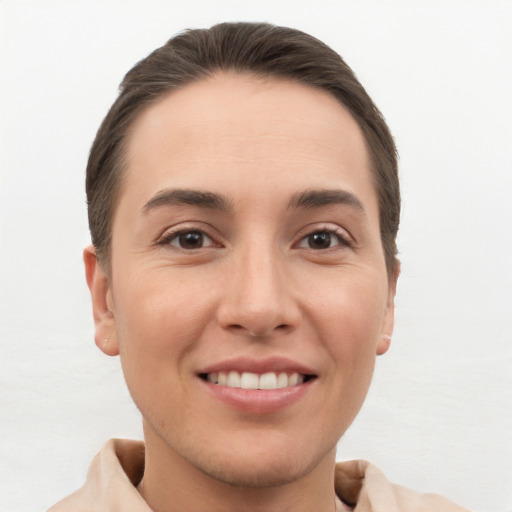 Joyful white young-adult female with short  brown hair and brown eyes