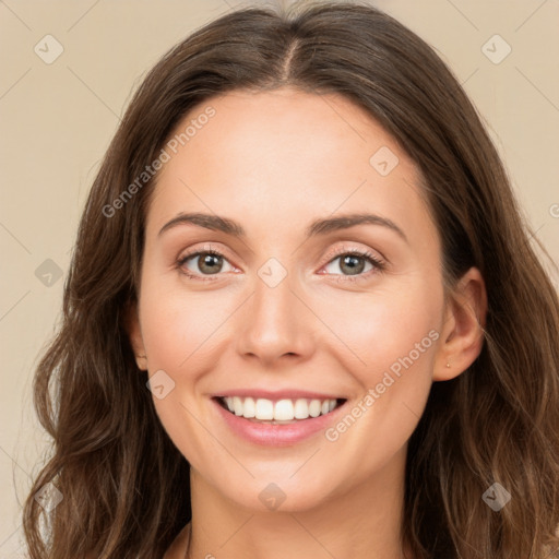 Joyful white young-adult female with long  brown hair and green eyes