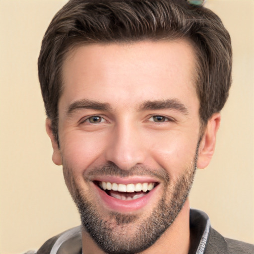 Joyful white young-adult male with short  black hair and brown eyes