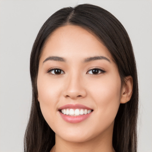 Joyful white young-adult female with long  black hair and brown eyes