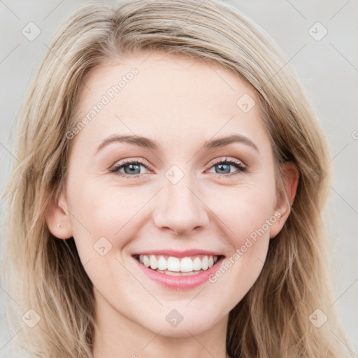 Joyful white young-adult female with long  brown hair and blue eyes