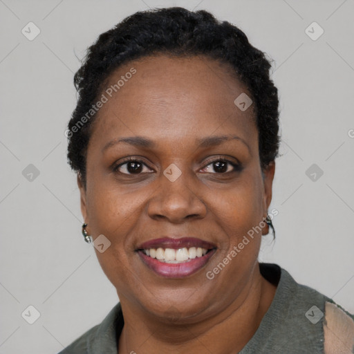 Joyful black adult female with short  black hair and brown eyes