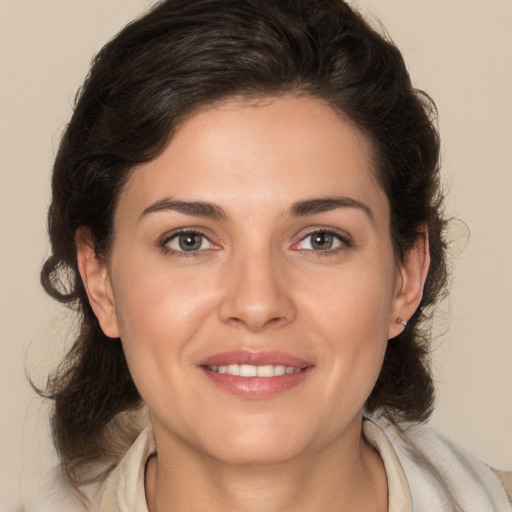 Joyful white young-adult female with medium  brown hair and brown eyes