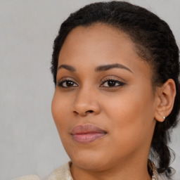 Joyful black young-adult female with long  brown hair and brown eyes