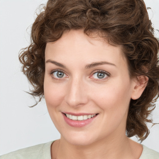 Joyful white young-adult female with medium  brown hair and green eyes