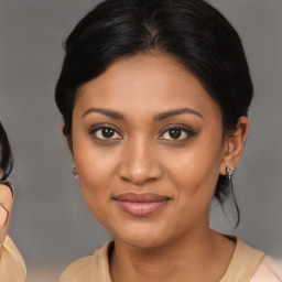 Joyful black young-adult female with medium  brown hair and brown eyes