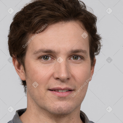 Joyful white adult male with short  brown hair and grey eyes