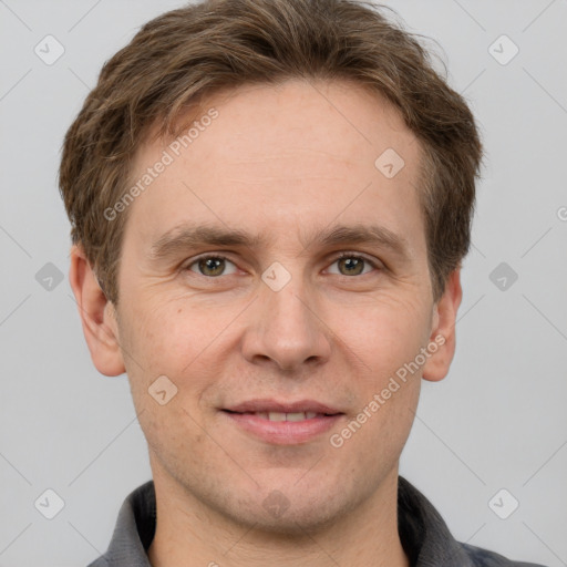 Joyful white adult male with short  brown hair and grey eyes