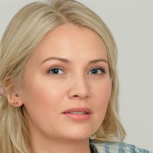 Joyful white young-adult female with medium  blond hair and blue eyes