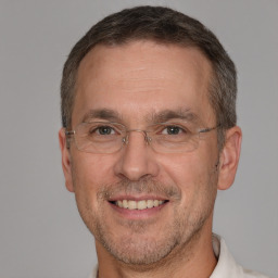 Joyful white adult male with short  brown hair and brown eyes