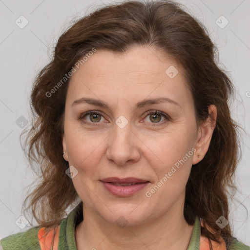 Joyful white adult female with medium  brown hair and green eyes