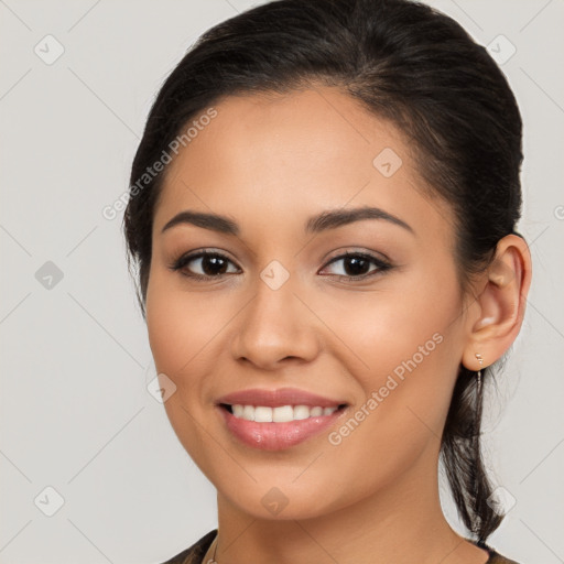 Joyful latino young-adult female with long  brown hair and brown eyes