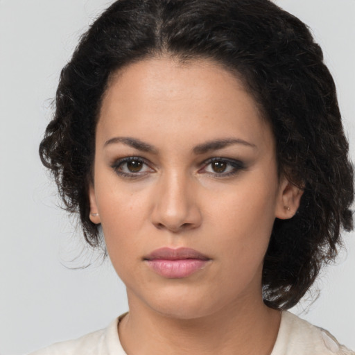 Neutral latino young-adult female with medium  brown hair and brown eyes
