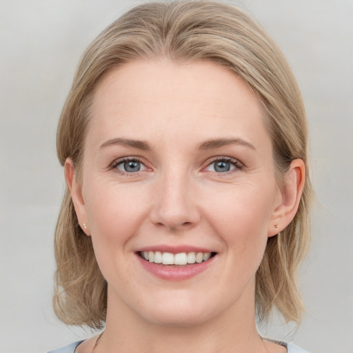 Joyful white young-adult female with medium  brown hair and blue eyes