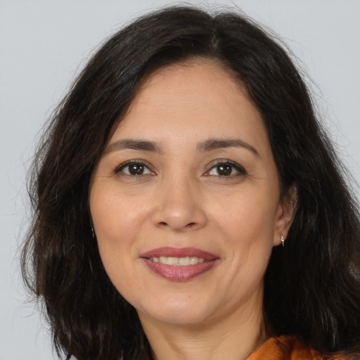 Joyful white adult female with long  brown hair and brown eyes