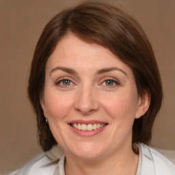 Joyful white adult female with medium  brown hair and grey eyes