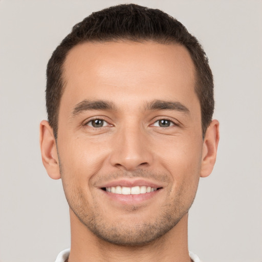 Joyful white young-adult male with short  brown hair and brown eyes