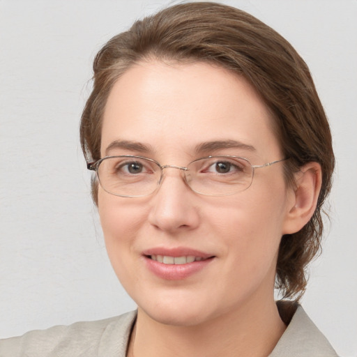 Joyful white adult female with medium  brown hair and blue eyes