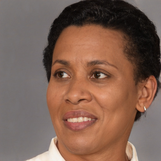 Joyful black adult female with short  black hair and brown eyes