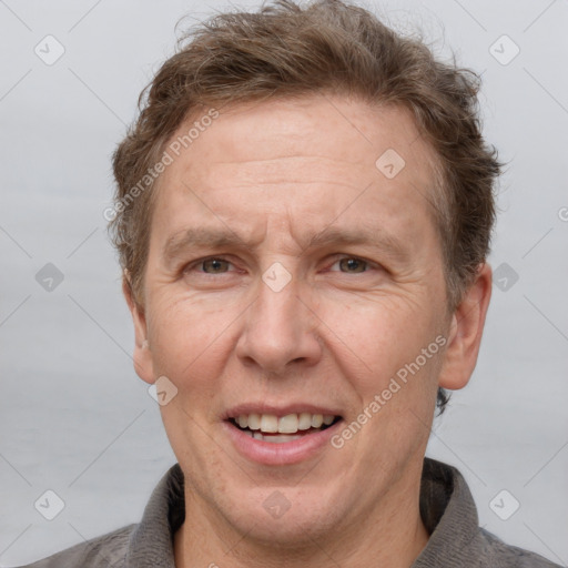 Joyful white adult male with short  brown hair and grey eyes