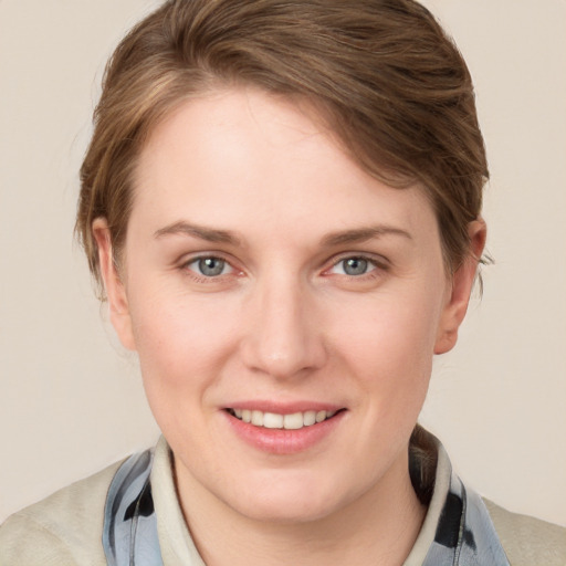 Joyful white young-adult female with medium  brown hair and blue eyes