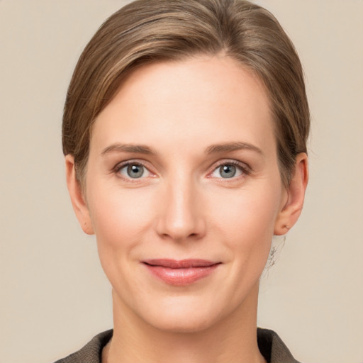 Joyful white young-adult female with short  brown hair and grey eyes