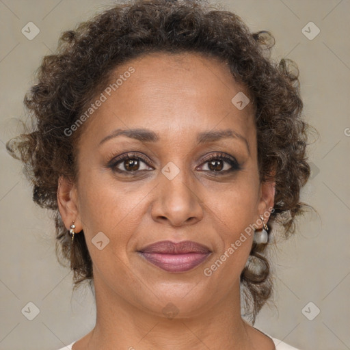 Joyful black adult female with medium  brown hair and brown eyes