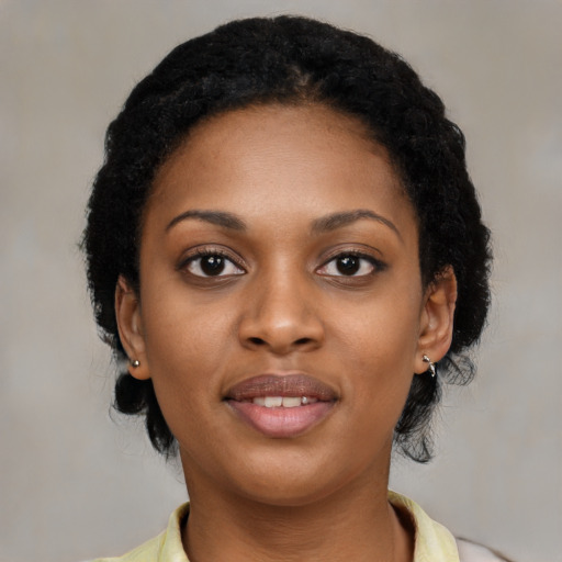 Joyful black young-adult female with medium  black hair and brown eyes